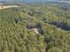 Aerial view of a house surrounded by lush green trees and tranquil landscape at 946 Gaithers Rd, Mansfield, GA 30055