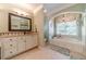 Spa-like bathroom with soaking tub, separate shower, and large window at 946 Gaithers Rd, Mansfield, GA 30055