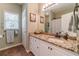 Bathroom with granite countertop, white cabinets and a large mirror at 946 Gaithers Rd, Mansfield, GA 30055