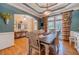 Bright dining room features hardwood floors, a rustic table, and access to the kitchen at 946 Gaithers Rd, Mansfield, GA 30055