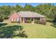 Brick home with flag, large yard, and lush landscaping at 946 Gaithers Rd, Mansfield, GA 30055