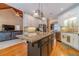 Open kitchen with large island, granite countertops, and stainless steel appliances at 946 Gaithers Rd, Mansfield, GA 30055