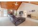 Spacious living room featuring a stone fireplace, vaulted ceiling, and comfortable sectional sofa at 946 Gaithers Rd, Mansfield, GA 30055