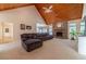 Open living room showcasing a stone fireplace, vaulted ceiling and comfy sectional sofa at 946 Gaithers Rd, Mansfield, GA 30055