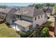 Birds eye view of the house's back, with a cozy, covered patio and an expansive yard at 231 Haney Rd, Woodstock, GA 30188
