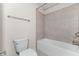 Clean and simple bathroom featuring a tiled shower-tub combination and a white toilet at 231 Haney Rd, Woodstock, GA 30188