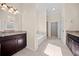 Bathroom with granite countertops, a large tub, and tiled floors at 231 Haney Rd, Woodstock, GA 30188