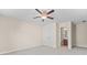 A bright bedroom featuring a ceiling fan, closet, and an attached bathroom at 231 Haney Rd, Woodstock, GA 30188