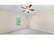 Cozy bedroom with a ceiling fan and a window view of lush greenery at 231 Haney Rd, Woodstock, GA 30188