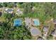 Aerial view of tennis courts, a swimming pool and parking area surrounded by dense trees at 231 Haney Rd, Woodstock, GA 30188