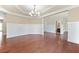 Spacious dining area features hardwood floors, elegant chandelier, and neutral tones at 231 Haney Rd, Woodstock, GA 30188