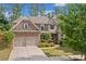 Beautiful two-story brick home with a two-car garage and manicured landscaping at 231 Haney Rd, Woodstock, GA 30188