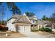 Two-story brick home with a two-car garage and landscaped yard at 231 Haney Rd, Woodstock, GA 30188