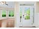 Bright entryway with decorative door, sidelights, transom window, and view into living room at 231 Haney Rd, Woodstock, GA 30188