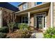 Inviting front entrance with a covered porch and charming landscaping at 231 Haney Rd, Woodstock, GA 30188