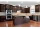 Stylish kitchen with dark cabinetry, granite countertops, and stainless steel appliances at 231 Haney Rd, Woodstock, GA 30188