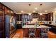 Modern kitchen with granite island, stainless steel appliances, and dark wood cabinets at 231 Haney Rd, Woodstock, GA 30188