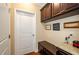 Convenient laundry room with built-in storage and granite countertop at 231 Haney Rd, Woodstock, GA 30188