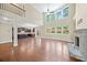 Open-concept living space with stone fireplace, hardwood floors, and abundant natural light at 231 Haney Rd, Woodstock, GA 30188