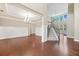 Bright living room boasts hardwood floors, white wainscoting, stairs, and modern chandelier at 231 Haney Rd, Woodstock, GA 30188