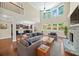 Open living room boasts high ceilings, large windows, hardwood floors, and fireplace at 231 Haney Rd, Woodstock, GA 30188