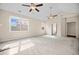 Large living room with carpet, high ceilings, two ceiling fans, and many windows at 231 Haney Rd, Woodstock, GA 30188