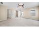 Spacious main bedroom with large windows, walk-in closet, and a ceiling fan at 231 Haney Rd, Woodstock, GA 30188
