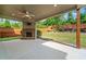 Covered patio featuring a ceiling fan and a brick fireplace overlooking a landscaped yard at 231 Haney Rd, Woodstock, GA 30188