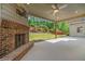 A covered patio with a brick fireplace offers a relaxing outdoor living space at 231 Haney Rd, Woodstock, GA 30188