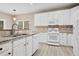 White kitchen with granite countertops and stainless steel appliances at 780 Treadstone Ct, Suwanee, GA 30024