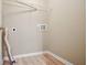 Small laundry room with shelving and vinyl flooring at 780 Treadstone Ct, Suwanee, GA 30024