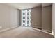 Spacious bedroom with large window and neutral decor at 20 10Th Nw St # 2104, Atlanta, GA 30309