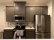 Modern kitchen with stainless steel appliances and gray cabinets at 815 Regal Sw Ln, Atlanta, GA 30331