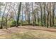 Large backyard bordered by trees and a wooden fence at 1707 Boulderview Se Dr, Atlanta, GA 30316