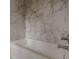 White bathtub with marble tile surround at 1707 Boulderview Se Dr, Atlanta, GA 30316