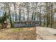 Newly renovated ranch home with gray brick exterior, modern porch, and long driveway at 1707 Boulderview Se Dr, Atlanta, GA 30316