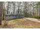 Newly renovated ranch home with gray brick exterior, modern porch, and long driveway at 1707 Boulderview Se Dr, Atlanta, GA 30316