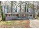 Newly renovated ranch home with gray brick exterior, modern porch, and long driveway at 1707 Boulderview Se Dr, Atlanta, GA 30316