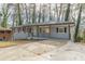 Newly renovated ranch home with gray brick exterior, modern porch, and long driveway at 1707 Boulderview Se Dr, Atlanta, GA 30316