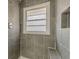 Clean shower with gray tile and built-in seat at 1707 Boulderview Se Dr, Atlanta, GA 30316