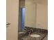 Bathroom vanity featuring granite countertop, mirror, faucet, and white basin at 250 Pharr Ne Rd # 1704, Atlanta, GA 30305