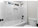 Clean bathroom with a shower/tub combo and marble tile at 115 Parkside Close, Alpharetta, GA 30022