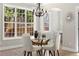 Bright dining area with glass table, white chairs, and hardwood floors at 115 Parkside Close, Alpharetta, GA 30022