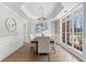 Elegant dining room with hardwood floors, chandelier, and large windows at 115 Parkside Close, Alpharetta, GA 30022