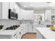 Modern white kitchen with stainless steel appliances and quartz countertops at 115 Parkside Close, Alpharetta, GA 30022