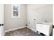 Laundry room with utility sink and ample shelving at 115 Parkside Close, Alpharetta, GA 30022