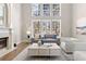 Spacious living room with hardwood floors, a fireplace, and large windows at 115 Parkside Close, Alpharetta, GA 30022