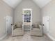 Cozy sitting area with two armchairs and a view overlooking the neighborhood at 115 Parkside Close, Alpharetta, GA 30022