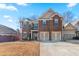 Brick two-story home with three-car garage and landscaping at 117 Gloster Mill Way, Lawrenceville, GA 30044