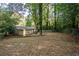 Extensive backyard with mature trees, a swing set, and a fenced boundary line at 118 Lucia Se Dr, Smyrna, GA 30082